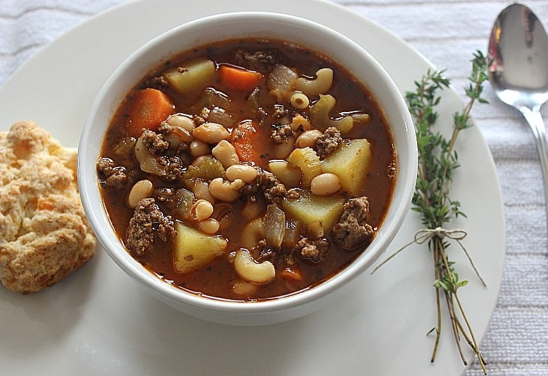 Hearty Hamburger Soup next to a baking powder biscuit.