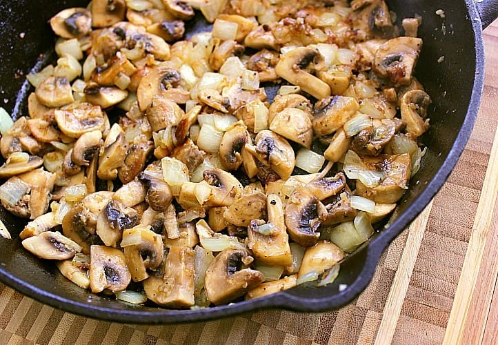 Skillet full of browned mushrooms.