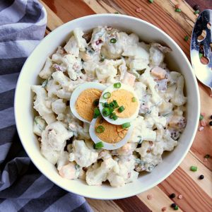 A low carb alternative for when you are craving potato salad, this Cauliflower Potato Salad is loaded with bacon, eggs and saucy goodness!
