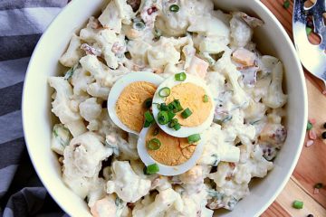 An easy low carb alternative for when you are craving potato salad, this Cauliflower Potato Salad is loaded with bacon, eggs and saucy goodness!