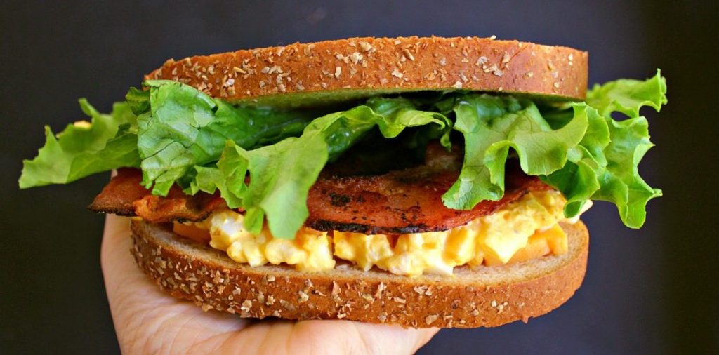 A classic Egg Salad Sandwich loaded with crispy bacon and sharp cheddar cheese. 