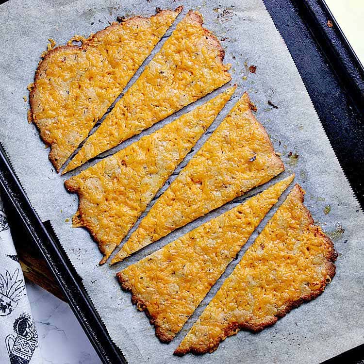 Baking sheet with freshly baked keto flatbread, sliced into 6.