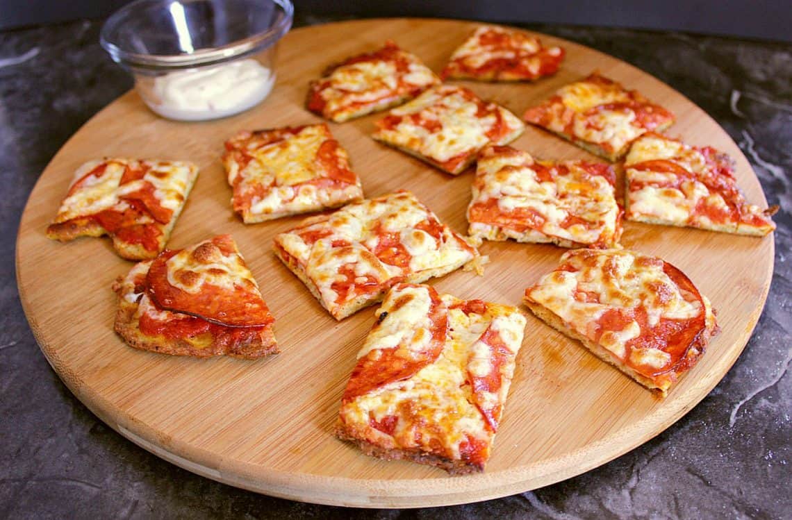 Cutting board with low carb pizza bites.