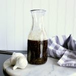 Jar of low carb teriyaki sauce on a marble cutting board.