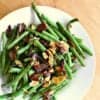 bowl of low carb green beans with almonds and bacon.