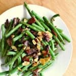 bowl of low carb green beans with almonds and bacon.