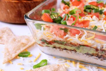 Dive into this low carb 7 layer dip for a fully loaded Mexican style appetizer perfect for potlucks, parties or a healthy snack!
