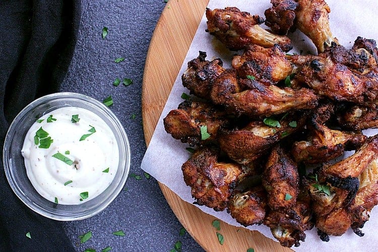 Low Carb Baked Chicken Wings on a serving platter next to some ranch dip.