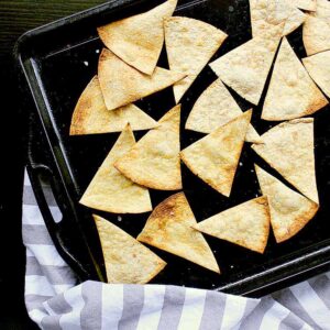 Low Carb Baked Tortilla Chips, laid out on a baking sheet, still warm from the oven.