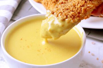 Crunchy Low Carb Baked Chicken Tender dipped in Low Carb Honey Mustard.