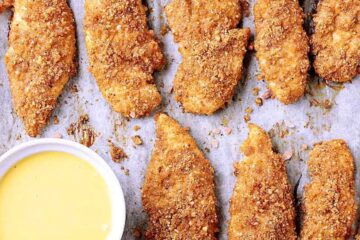 Baking sheet filled with Crunchy Low Carb Baked Chicken Tenders hot from the oven, filling the air with their delicious aroma.