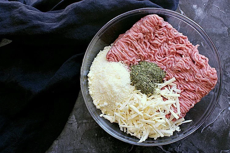 Mixing bowl with mozzarella, parmesan and spicy spaghetti seasoning.