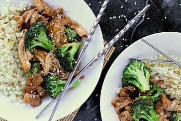Two bowls of keto teriyaki chicken with cauliflower rice on the side.