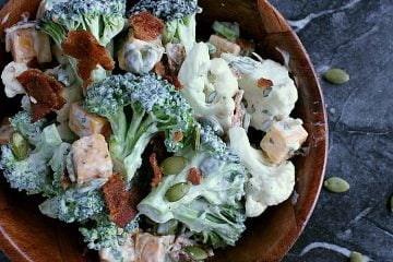 Single bowl of ranch cauliflower broccoli salad with bacon and cheese.