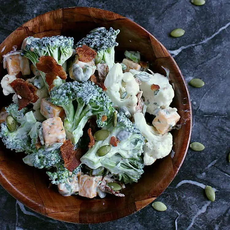Single bowl of ranch cauliflower broccoli salad with bacon and cheese.