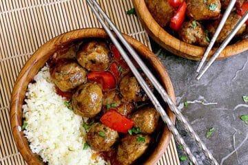 Two wooden bowls of keto sweet and sour meatballs with cauliflower rice.