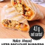 A keto breakfast burrito sliced in half. Text reads: mama bear's cookbook, make ahead keto breakfast burritos with ham, peppers & cheese, 4.1 g net carbs.
