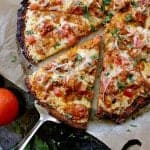 Keto Butter Chicken Pizza sliced into 8 pieces and garnished with cilantro.