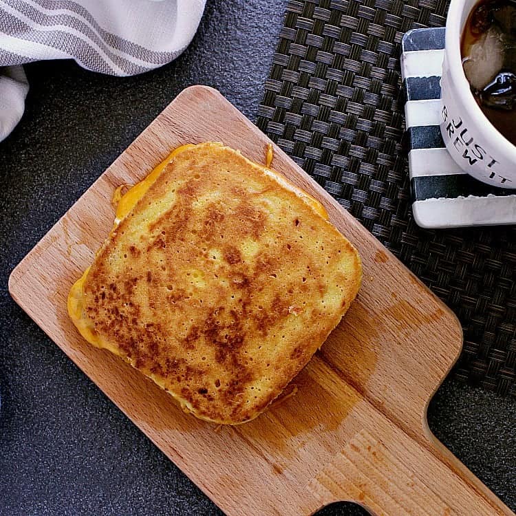 Keto Grilled Cheese, hot from the skillet, ready to be sliced in half and devoured.