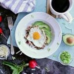 Low Carb Hash Boat. Bed of roasted radishes with bacon, grated cheese and green onion. Fried egg on top with sliced avocado beside it.