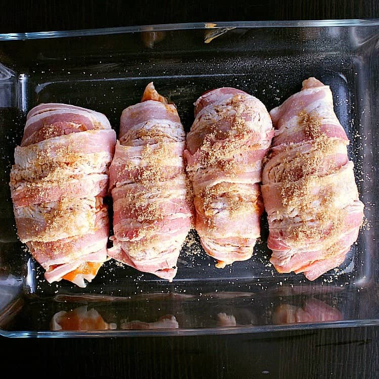 Bacon wrapped stuffed chicken breasts ready to be baked.