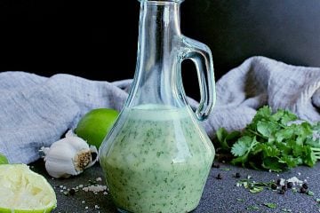 Glass jar filled with keto cilantro lime dressing.