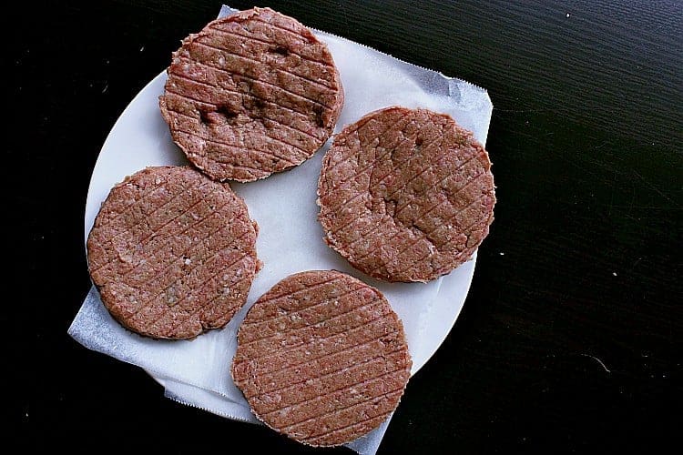 Four burger patties, formed and ready for the barbecue.
