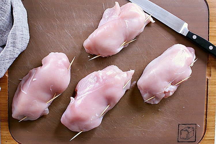 All four breasts sealed with toothpicks, ready to be breaded.