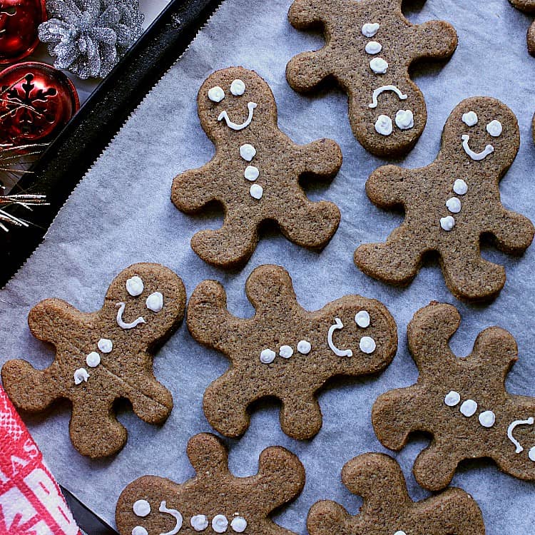 Baking sheet with decorated keto gingerbread cookies.
