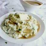 Bowl of keto mashed cauliflower topped with butter and keto gravy.