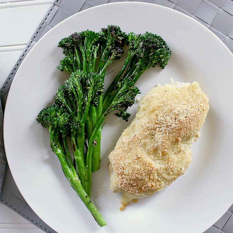 Plate with chicken cordon bleu and garlic sautéed broccolini.