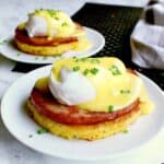 Two plates each with a keto eggs benedict and garnished with chives.