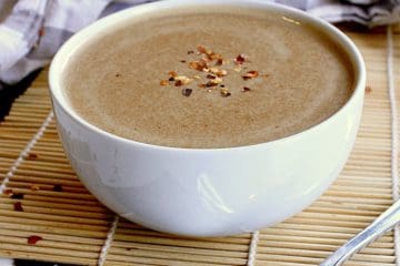 Bowl of keto peanut sauce, garnished with extra red pepper flakes.