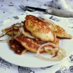 Plate with fried Keto Pierogies and onion.