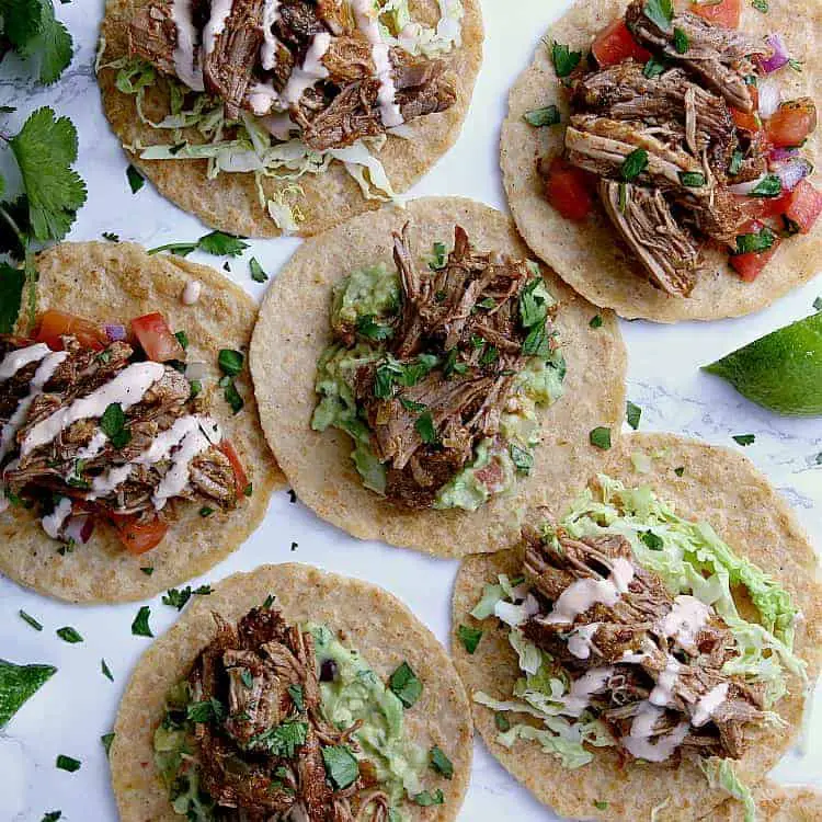 Almond flour tortillas filled with toppings and keto carnitas.