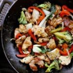 Cast iron wok with keto chicken stir fry, ready to be served.