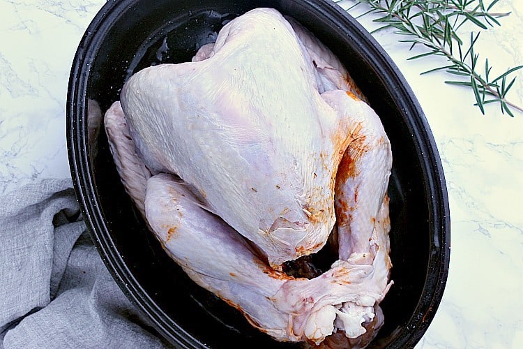 Roasting pan with the prepared turkey, ready to be baked.