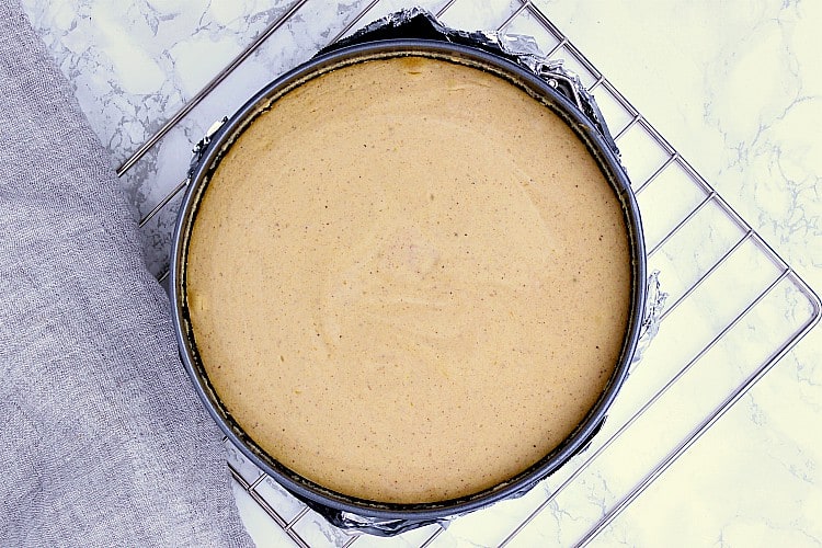 Fully cooked Keto Pumpkin Cheesecake, still warm, cooling to room temperature before being refrigerated.