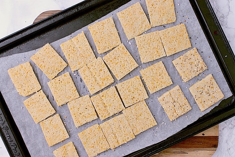 Crackers are halfway baked and have just been cut and flipped. 
