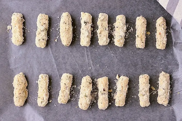 Baking sheet lined with wax paper and the prepared Keto Mozzarella Sticks