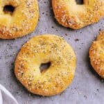 Four Keto Everything Bagels fresh from the oven, on a baking sheet.