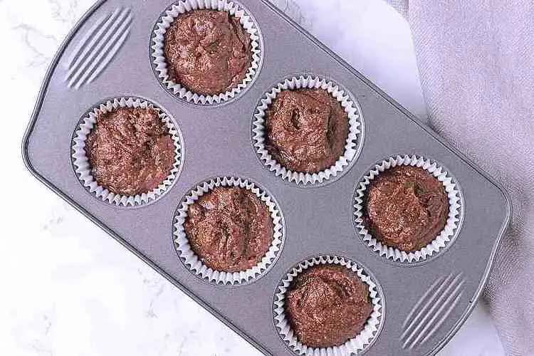 A 6 tin muffin tray with filled liners.