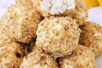 A stack of lemon fat bombs. The top bomb has a bite removed.