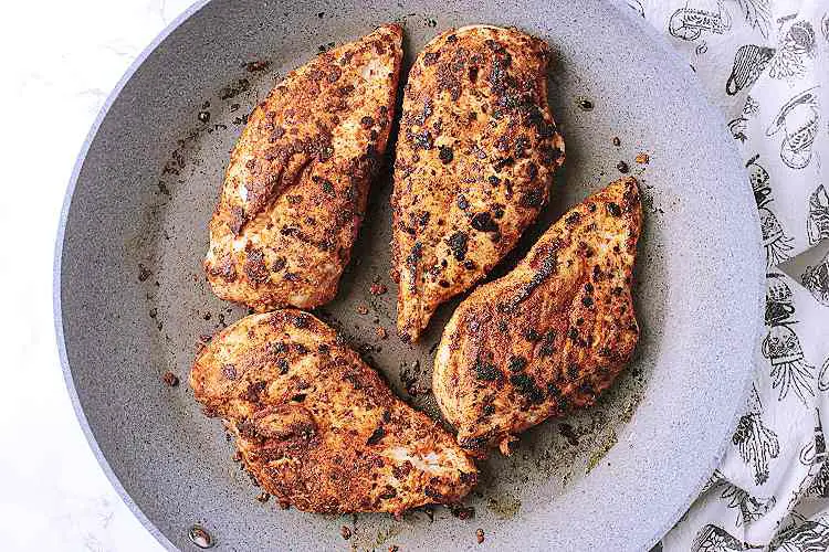 Seared chicken breasts in a skillet