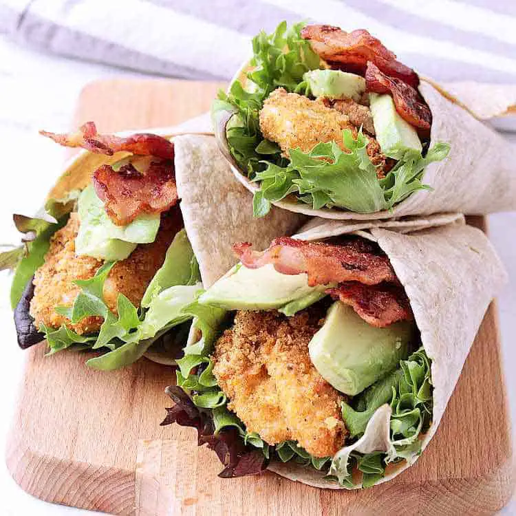 Three crispy keto chicken wraps with lettuce, avocado and bacon.
