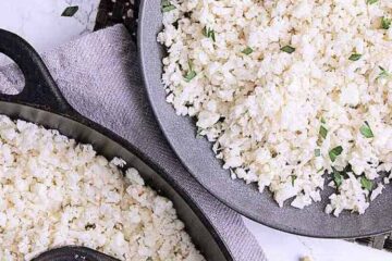 A bowl and cast iron skillet with keto cauliflower rice.