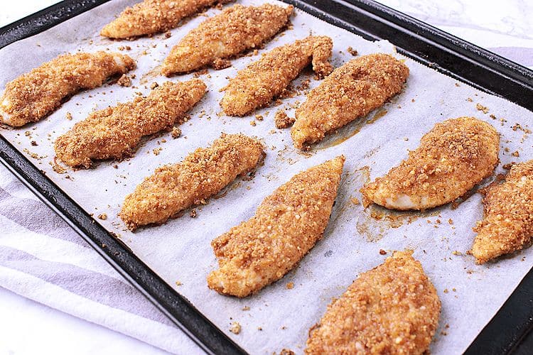 Baking sheet with baked Keto chicken tenders.