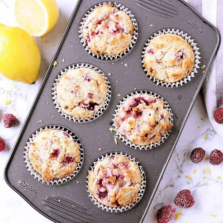 A muffin tray with 6 Keto raspberry muffins.
