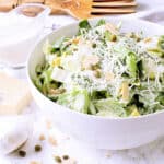 A white bowl with Keto Caesar Dressing, garnished with parmesan cheese.