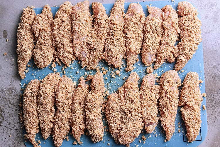 Breaded Keto chicken tenders on a cutting board.